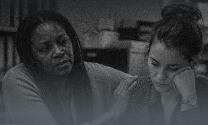 One woman comforting another at work
