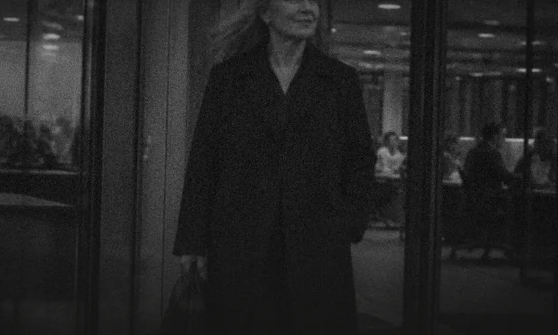 A woman walking through an empty office at night